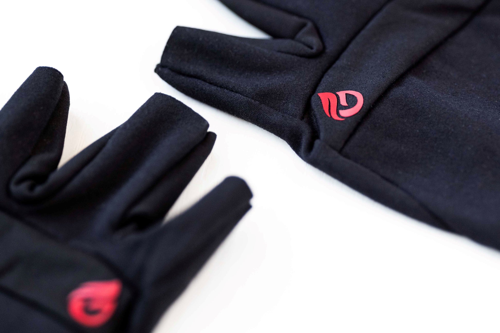 close of fabric material and red logo on glove